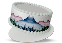 Decorative cake with mountain and forest design on a white background