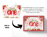 Decorative cake topper with 'Sweet One' text and strawberry design, showing application instructions.