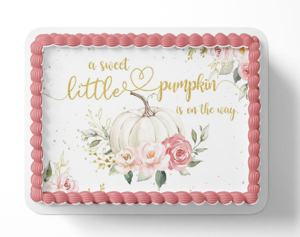 Baby shower cake with pumpkins, flowers, and text 'a sweet little pumpkin is on the way' on a white background.