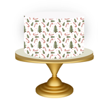 Cake with Christmas-themed design on a gold stand against a white background