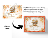 Edible cake image with 'Falling in Love with Baby' text and autumn-themed design, shown on a cake board.