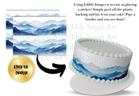 Edible cake border with mountain design and text on a white background